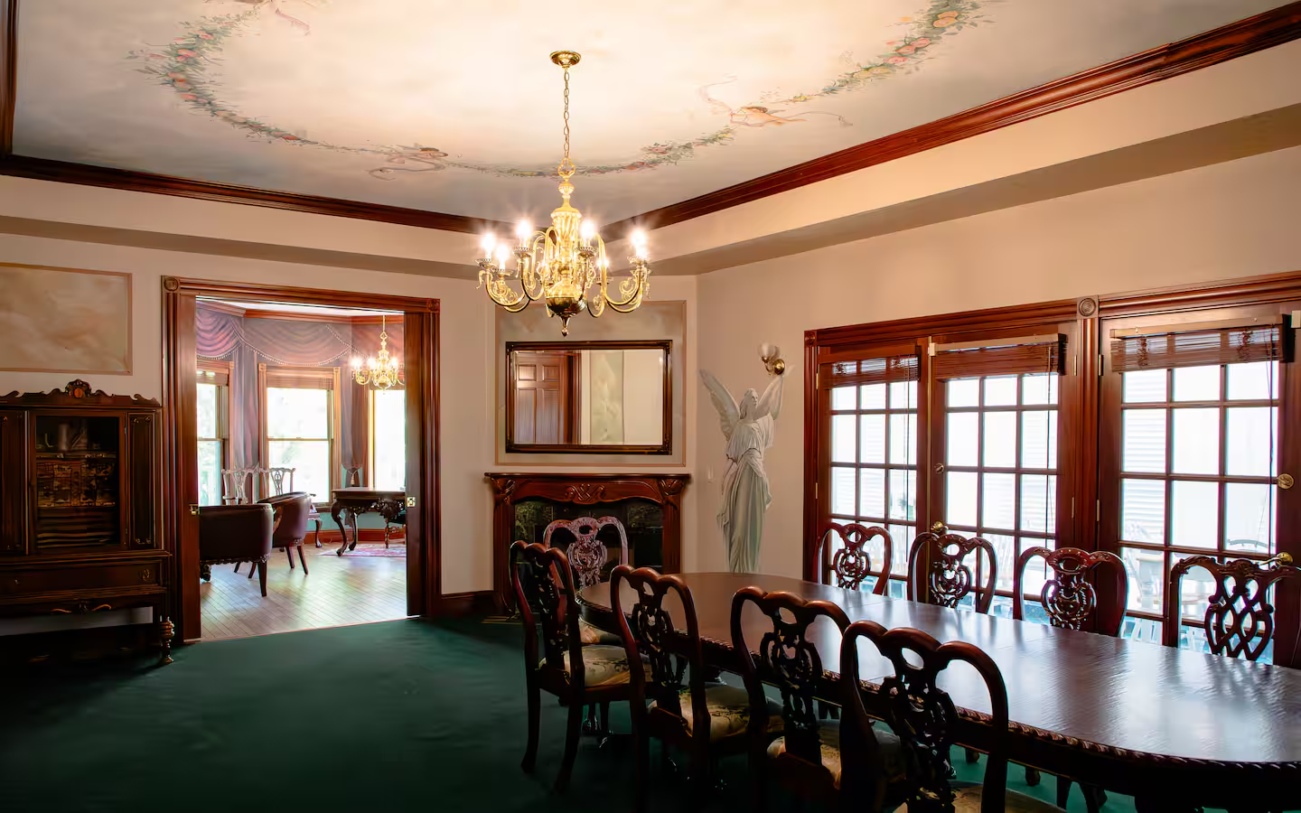 Formal dining room with chandelier and mural ceiling